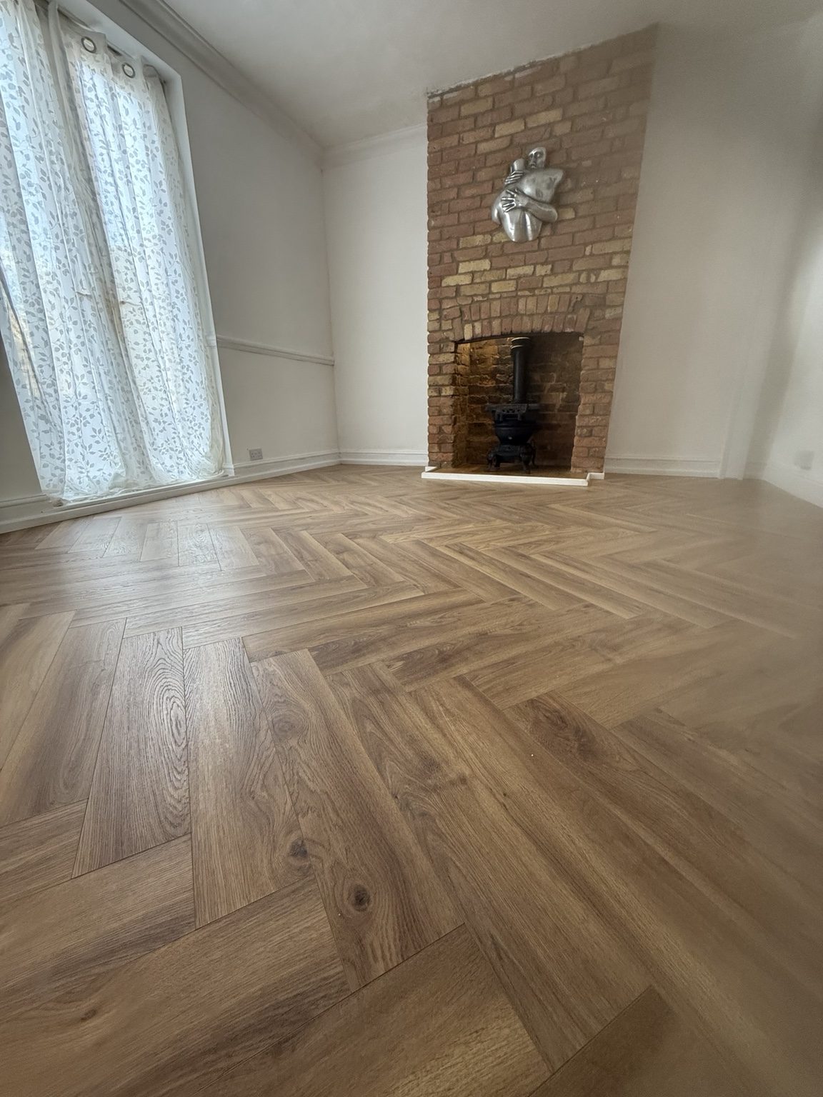 Herringbone floor with brick fireplace